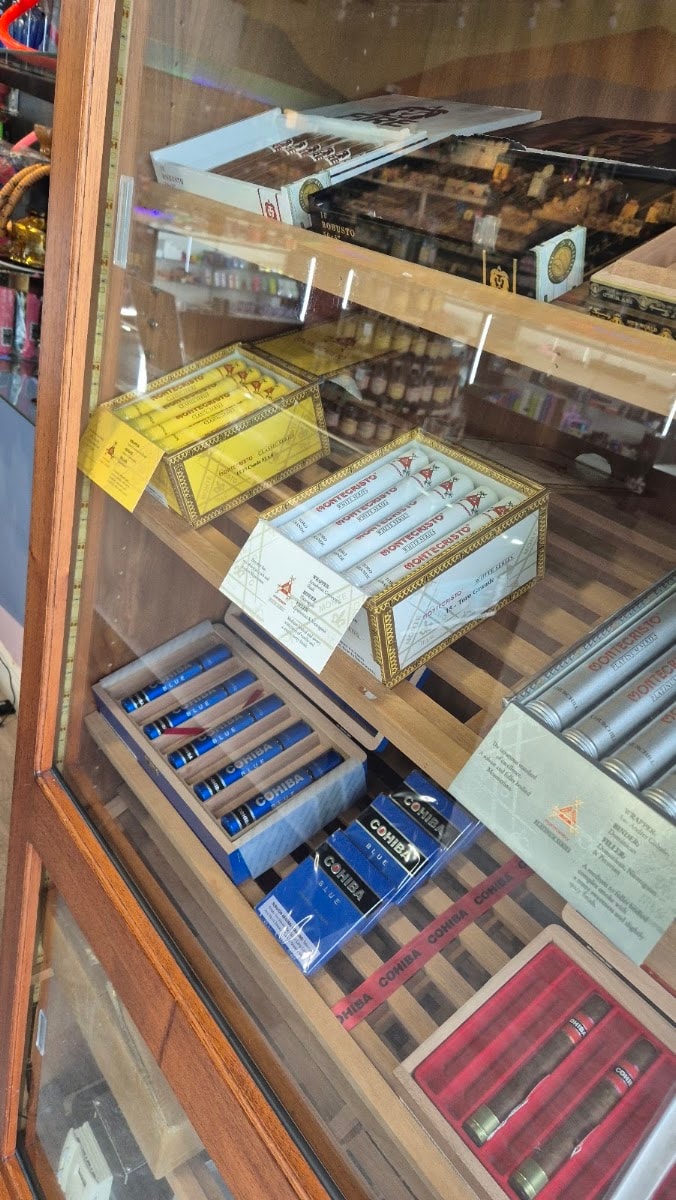 The cigar case, boxes stacked behind glass.
